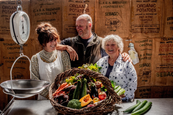 The Bryant family with a large basket of vegetables