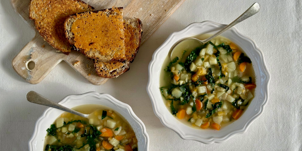 Two bowls of winter root vegetable soup and cheese toast.