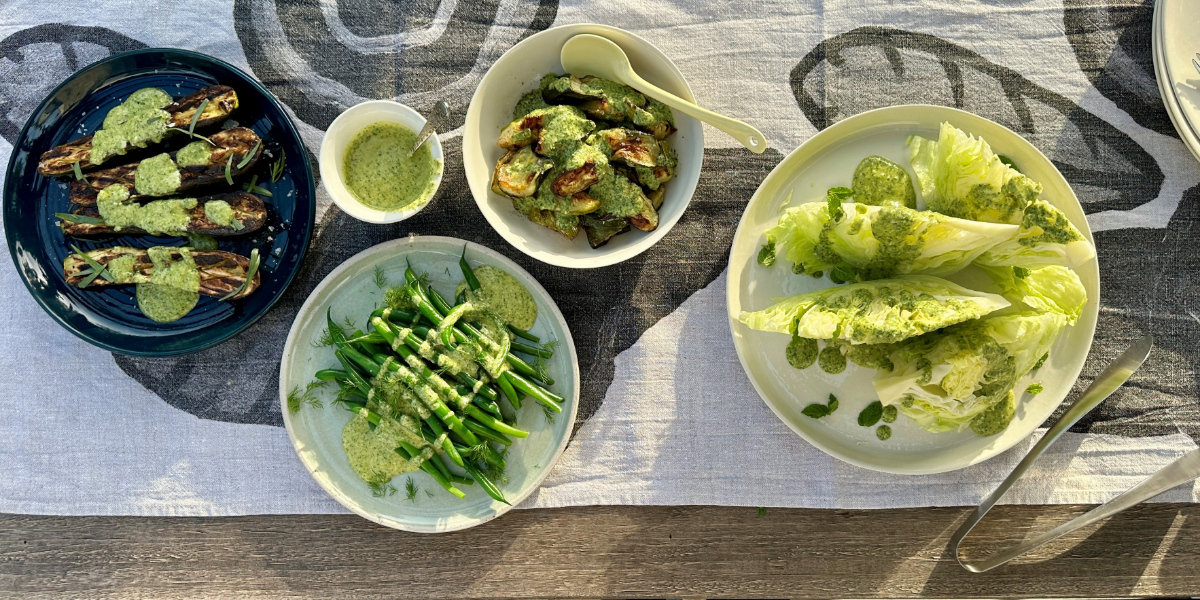 Bowls of summer vegetables and salads with herb and feta dressing.