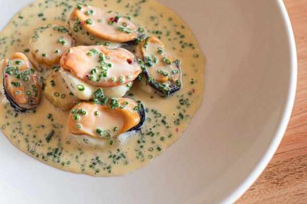 Serving of Flinders mussels in sauce